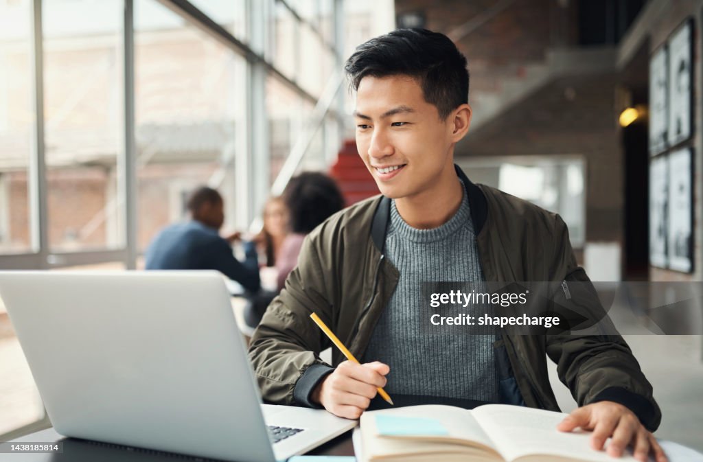 College student, asian man and studying on laptop at campus, research and education test, exam books and course project. Happy Japanese university student, knowledge and learning online technology