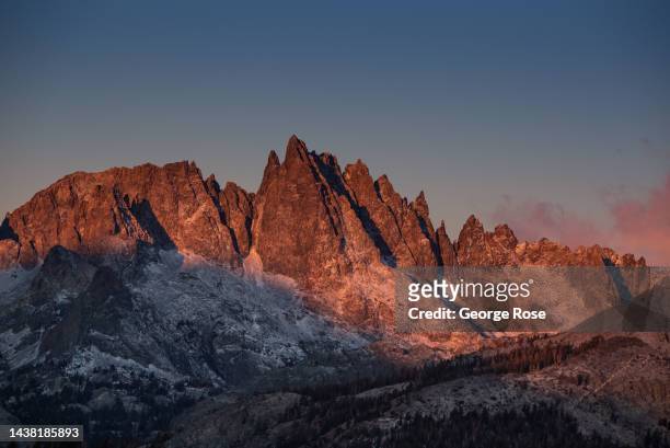 The Minarets, an unusual collection of rock spires formed by tectonic uplift along the Sierra Crest, are viewed at sunrise from Minaret View on...