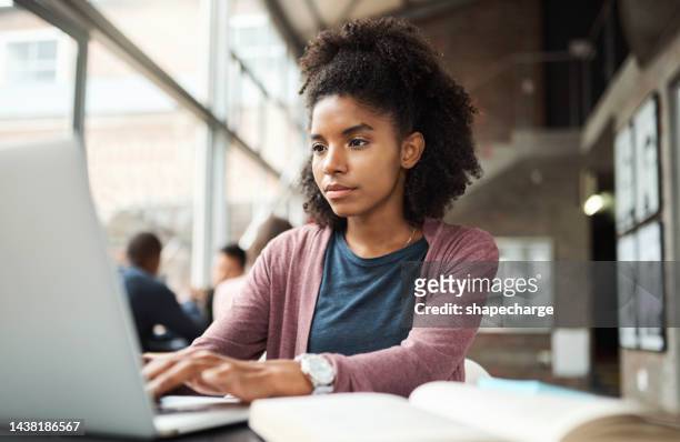 student education, laptop and black woman typing research assignment for university, college or school study project. learning, scholarship and african girl writing story for usa black history month - scholarship award stock pictures, royalty-free photos & images