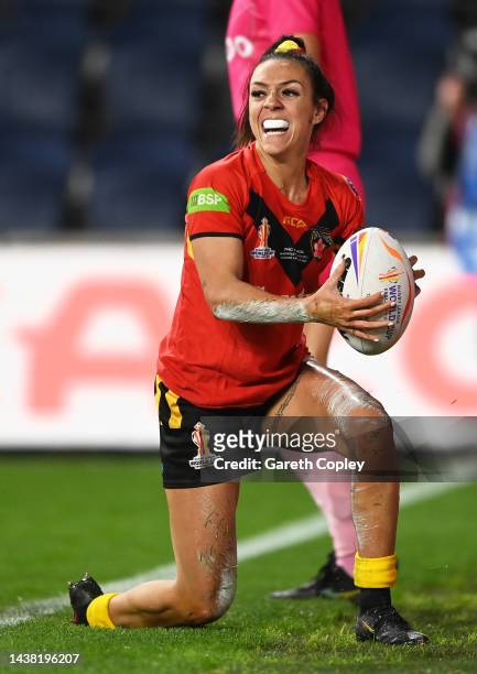 Anika Butler of Papua New Guinea celebrates after scoring their team's seventh try during the Women's Rugby League World Cup Group A match between...