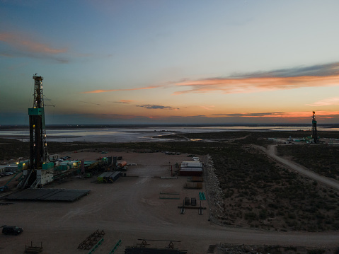 Sunset shot of an oil Fracking Drill Rig Under Dramatic Sunset Sky in the Permian Basin in West Texas or New Mexico