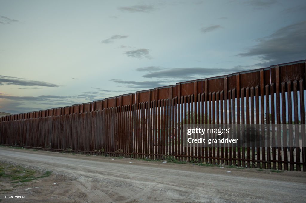 Moody Night Shot of Border Wall Between El Paso Texas USA and Juárez Chihuahua Texas at Puerto Anapra