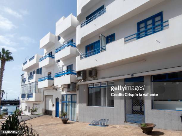 beach apartments with blue windows and doors, building facade - isla de lanzarote stock pictures, royalty-free photos & images