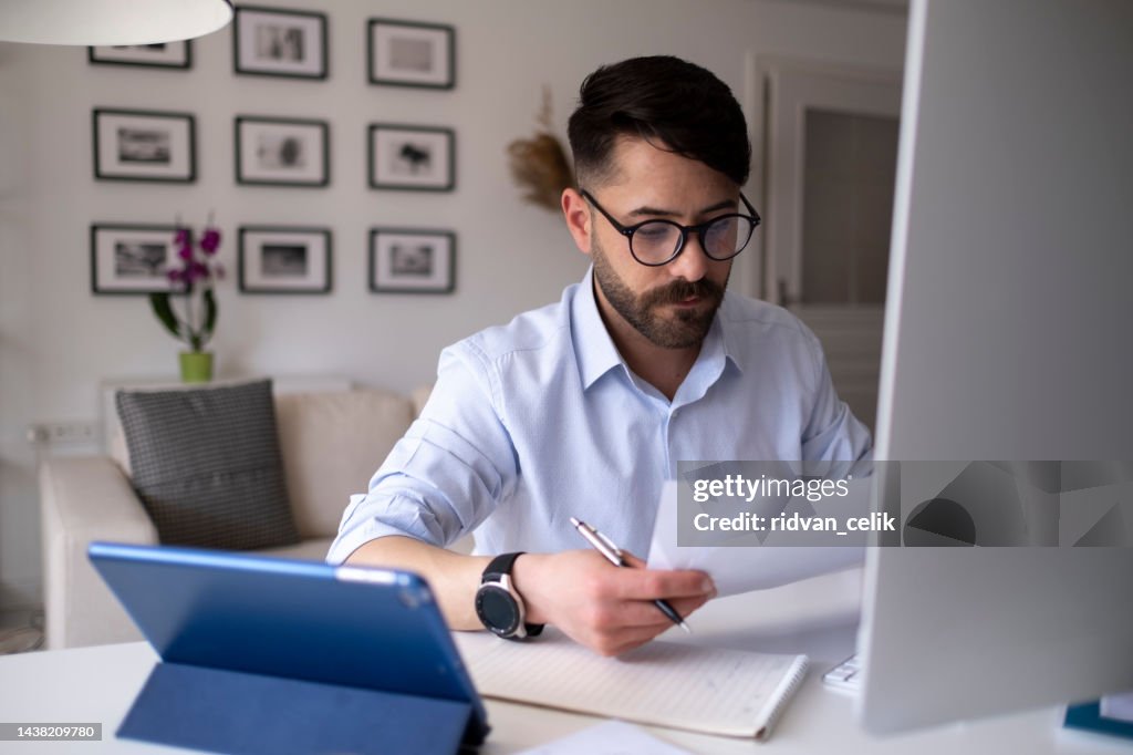 Business accounting concept, Business man using calculator with computer laptop, budget and loan paper in office.