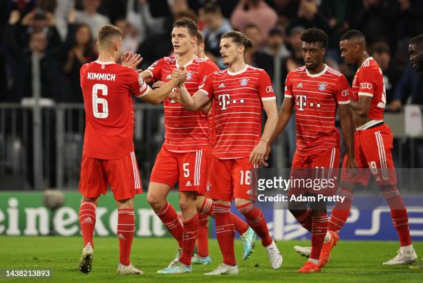 Benjamin Pavard celebrates with Joshua Kimmich and Marcel Sabitzer of Bayern Munich after scoring their team's first goal during the UEFA Champions...