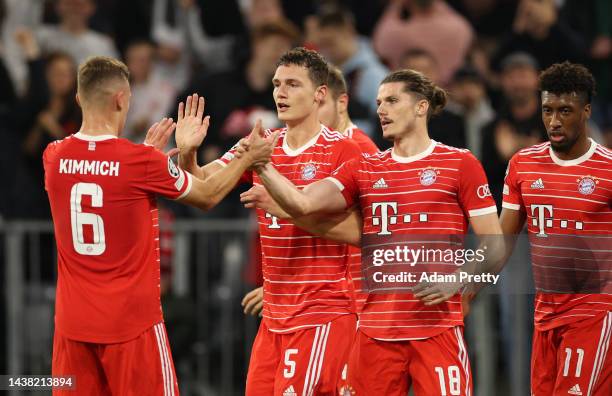 Benjamin Pavard celebrates with Joshua Kimmich and Marcel Sabitzer of Bayern Munich after scoring their team's first goal during the UEFA Champions...