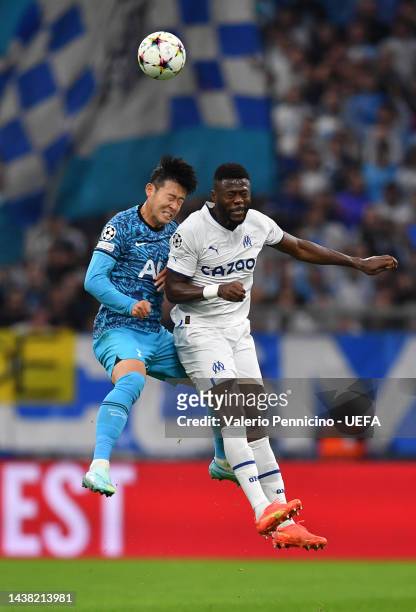 Son Heung-Min of Tottenham Hotspur jumps for the ball with Chancel Mbemba of Marseille during the UEFA Champions League group D match between...