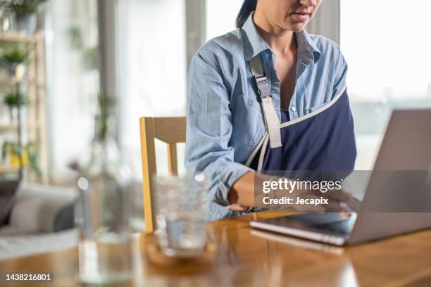 woman working on laptop - ferido imagens e fotografias de stock