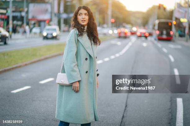 fashion woman crossing a street in the city - mint green stock pictures, royalty-free photos & images