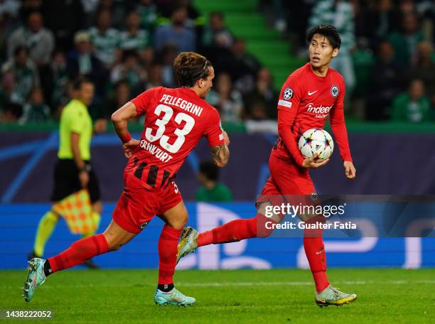 Daichi Kamada of Eintracht Frankfurt celebrates scoring their side's first goal from a penalty with teammate Luca Pellegrini during the UEFA...