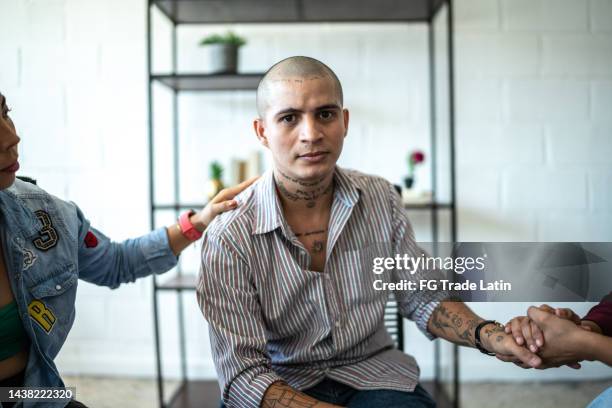 portrait of young man during a therapy at mental health center - victim advocacy stock pictures, royalty-free photos & images