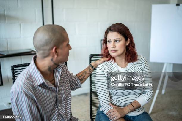 mid adult woman receiving a advice during a psychotherapy - victim stock pictures, royalty-free photos & images