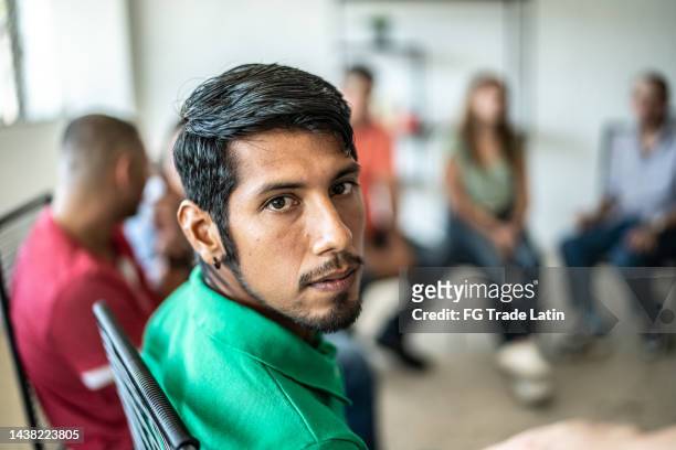 portrait of mid adult man during a group therapy - man reliable learning stock pictures, royalty-free photos & images