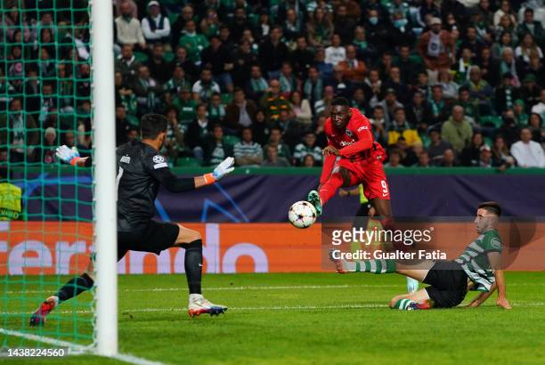 Randal Kolo Muani of Eintracht Frankfurt scores their side's second goal as Antonio Adan of Sporting CP attempts to make a save during the UEFA...