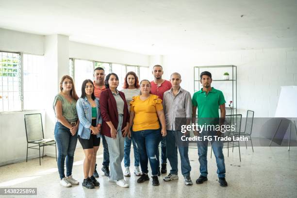 portrait of a team at community center - employee welfare stockfoto's en -beelden