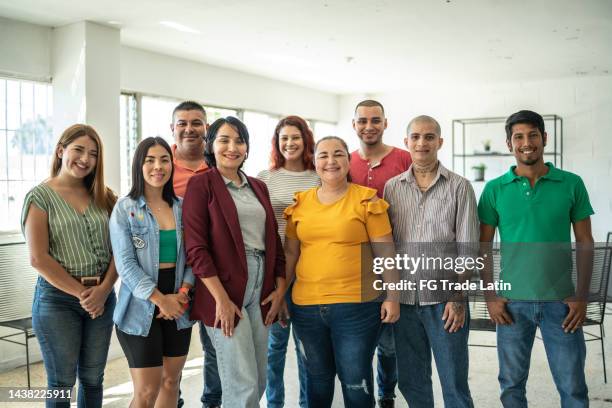 portrait of a team at community center - employee welfare stockfoto's en -beelden