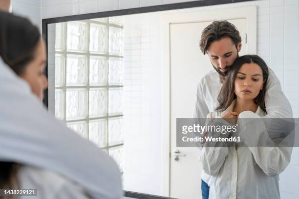 couple in love standing infront of mirror - jealousy stock pictures, royalty-free photos & images