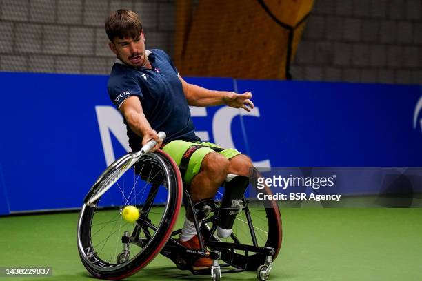 Martin de la Puente of Spain plays a forehand in his men's doubles match with Gustavo Fernandez of Argentina against Tom Egberink of the Netherlands...