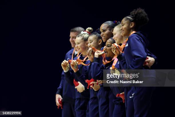 Jordan Chiles of United States bites her medal on the podium after her team win the Gold medal in the Women's Team Final during Day Four of the 2022...