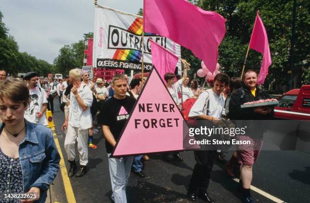 Marchers carrying a pink triangle with the words: 'Never Forget' at the Lesbian and Gay Pride event, London, 18th June 1994. The pink triangle began...