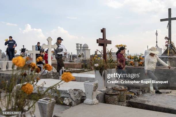 Family arrives at the San Pedro Abajo cemetery to visit their dead relatives during 'Day of the Dead' celebrations on November 1, 2022 in Temoaya,...