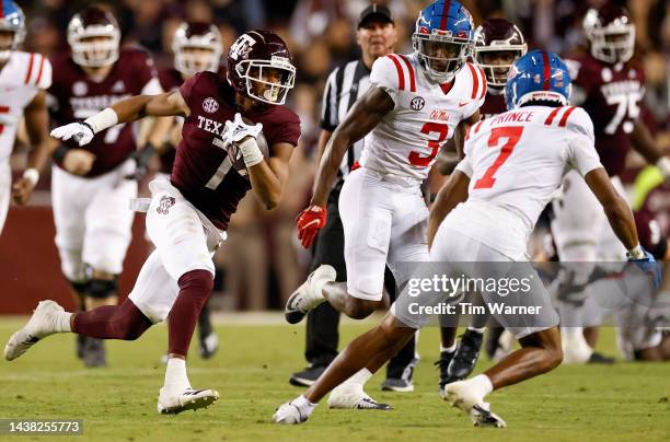 Moose Muhammad III of the Texas A&M Aggies runs after a catch while defended by Deantre Prince of the Mississippi Rebels and Otis Reese in the second...