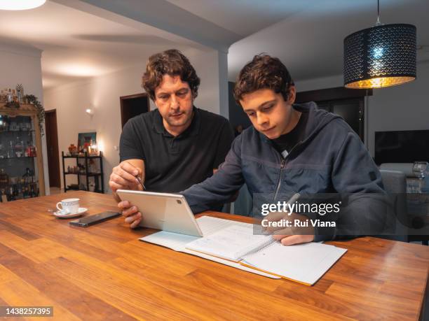 father helping son with homework - dad homework stock pictures, royalty-free photos & images