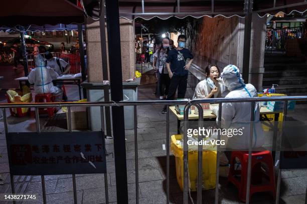 People queue up for COVID-19 nucleic acid tests during a new round of citywide antigen and nucleic acid testing on October 31, 2022 in Guangzhou,...