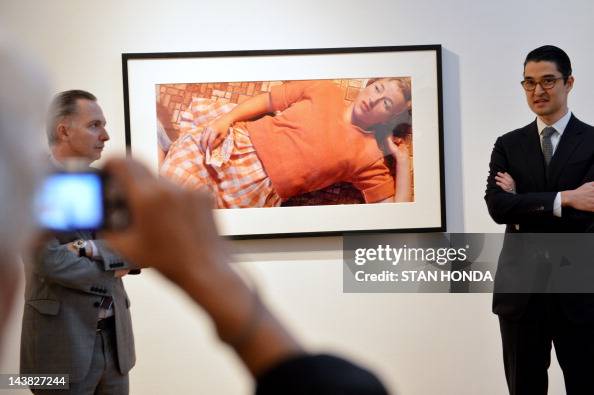 A woman takes a photograph of "Untitled A woman takes a photograph of "Untitled