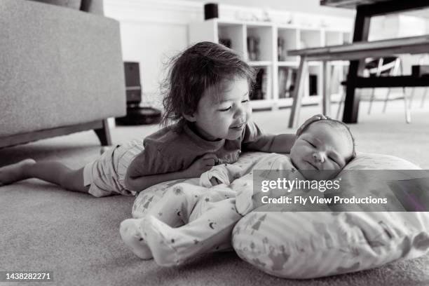 proud toddler girl with baby brother - eurasian ethnicity stock pictures, royalty-free photos & images