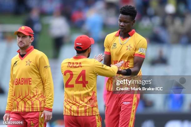 Sikandar Raza and Blessing Muzarabani of Zimbabwe celebrate a wicket during the ICC Men's T20 World Cup match between Zimbabwe and Netherlands at...