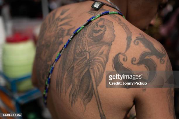 Tattooed Santa Muerte is seen on a gang member back on November 01, 2022 in Tepito, Mexico. People from across the city go to Tepito, the most...