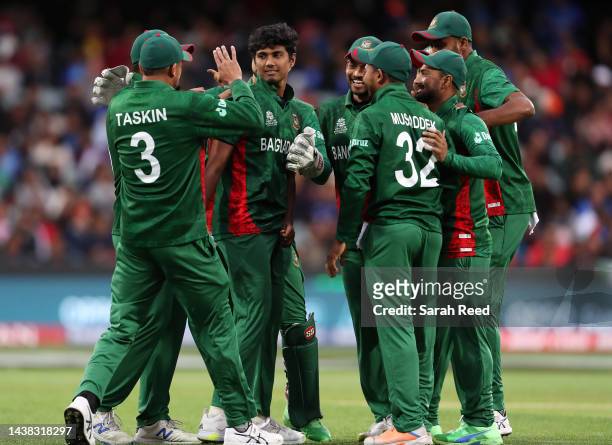 Hasan Mahmud of Bangladesh surrounded by team mates for the wicket of Rohit Sharma of India during the ICC Men's T20 World Cup match between India...