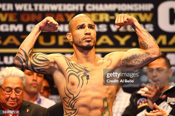 Super welterweight champion Miguel Cotto poses after weighing in at 154 pounds during the official weigh-in for his bout against Floyd Mayweather Jr....