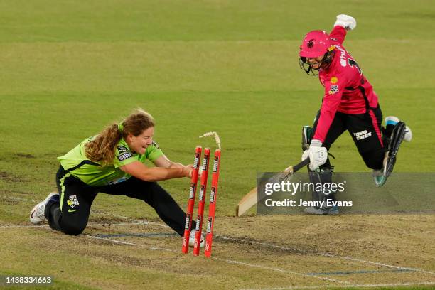 Nicole Bolton of the Sixers is run out by Belinda Vakarewa of Thunder during the Women's Big Bash League match between the Sydney Thunder and the...