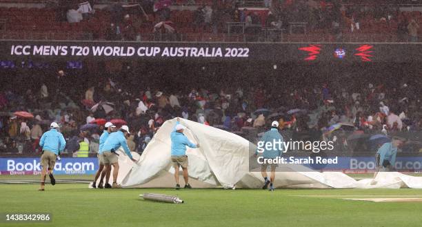 The covers come on as the rain starts during the ICC Men's T20 World Cup match between India and Bangladesh at Adelaide Oval on November 02, 2022 in...