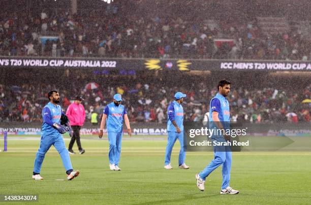 Indian players walk off as the rain comes down during the ICC Men's T20 World Cup match between India and Bangladesh at Adelaide Oval on November 02,...