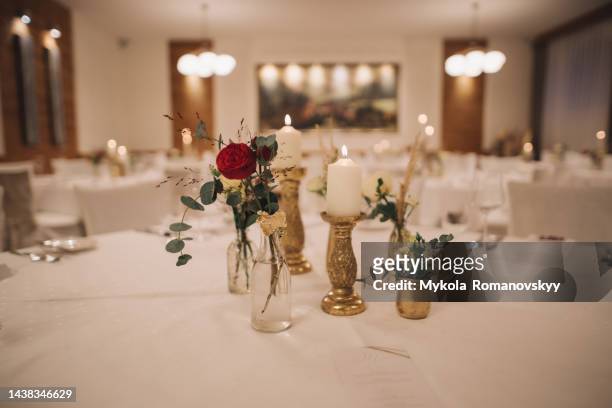 stylishly served table with flowers and candles in the restaurant. - rose ceremony stock pictures, royalty-free photos & images