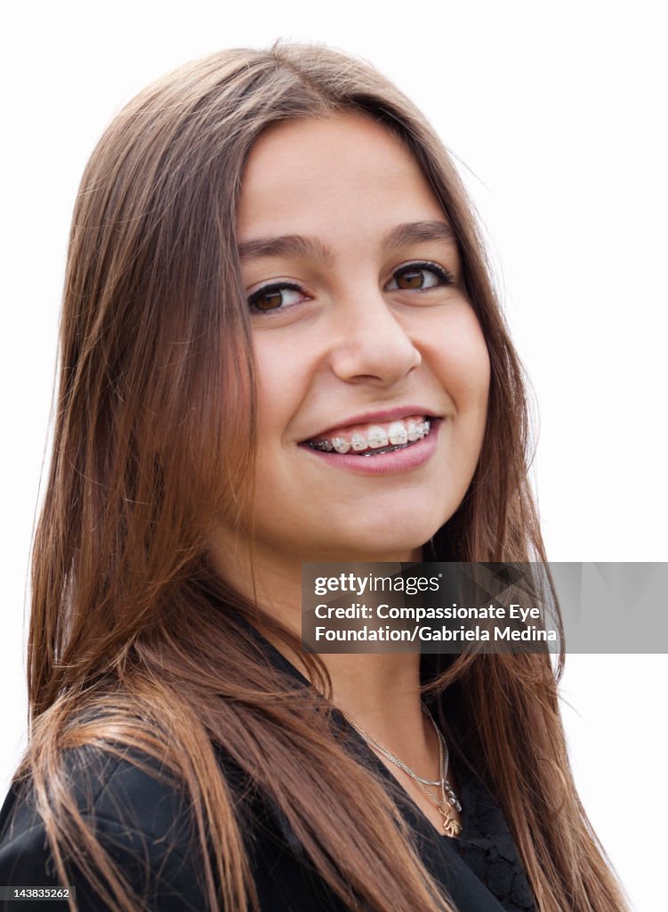 Portrait of young woman with braces, smiling