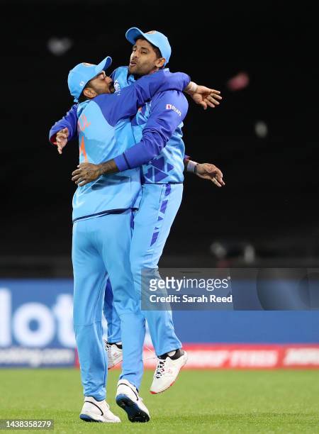 Rahul of India embraces Suryakumar Yadav of India after he took the catch to dismiss Najmul Shanto of Bangladesh for 21 runs during the ICC Men's T20...
