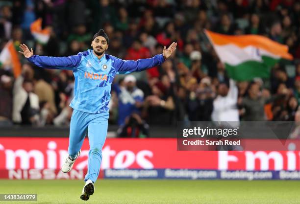 Arshdeep Singh of India runs towards Hardik Pandya of India after he bowled Musaddek Hossain of Bangladesh for 6 runs during the ICC Men's T20 World...