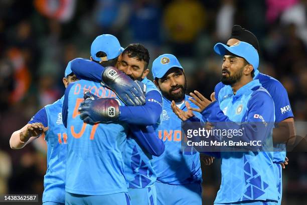 Dinesh Karthik and Deepak Hooda of India celebrate a wicket during the ICC Men's T20 World Cup match between India and Bangladesh at Adelaide Oval on...