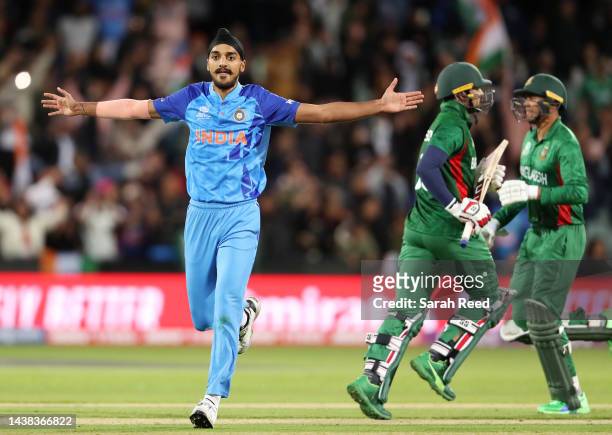 Arshdeep Singh of India bowls the last ball of the night and celebrates the win with Quazi Nurul Hasan Sohan and Taskin Ahmed of Bangladesh during...