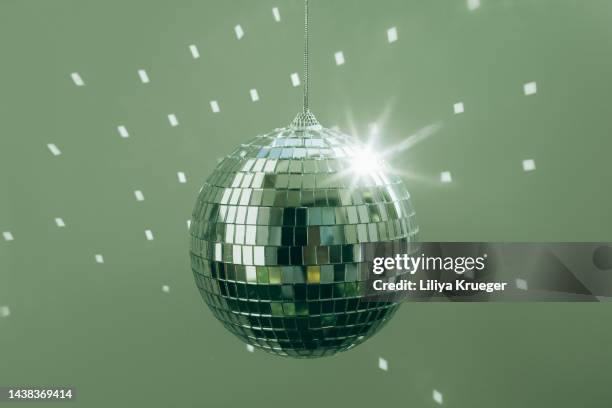 disco ball against green background. - heritage round one stock pictures, royalty-free photos & images