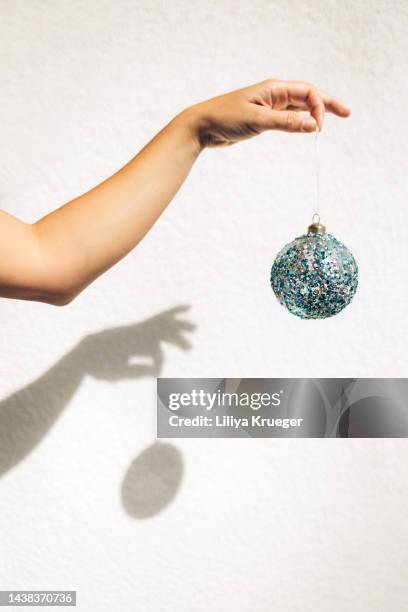 woman's hand holding a christmas toy. - woman picking up toys stock pictures, royalty-free photos & images