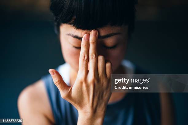 beautiful woman meditating - lotuspositie stockfoto's en -beelden