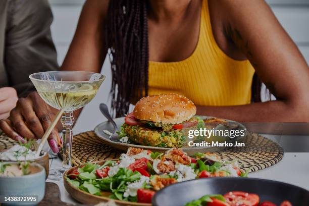 sophisticated woman enjoying the cocktail party and vegan burgers - cocktail recipe stock pictures, royalty-free photos & images