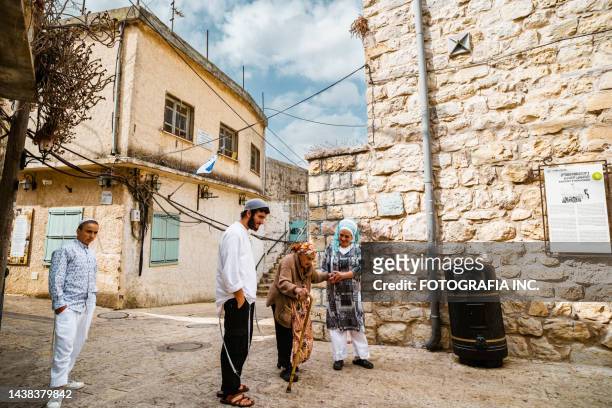 jewish family in old  neighborhood of druze village of peki'in, israel - orthodox judaism stock pictures, royalty-free photos & images