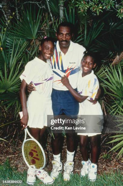 Portrait of tennis player sisters Venus and Serena Williams from the United States with their father Richard Williams during a training session on...