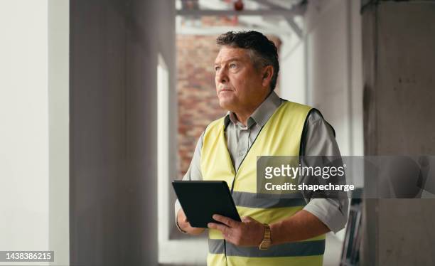 construction, tablet and construction worker planning, working and thinking of home renovation on site. building, engineering and house developer man with idea on technology for a maintenance project - quality control stockfoto's en -beelden
